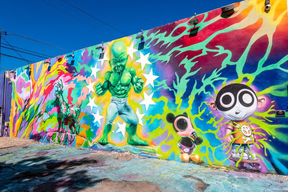 Graffiti art on The Wynwood Walls featuring cartoons, lightning, and stars.