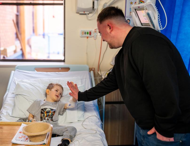 Luke Littler visiting a hospital.