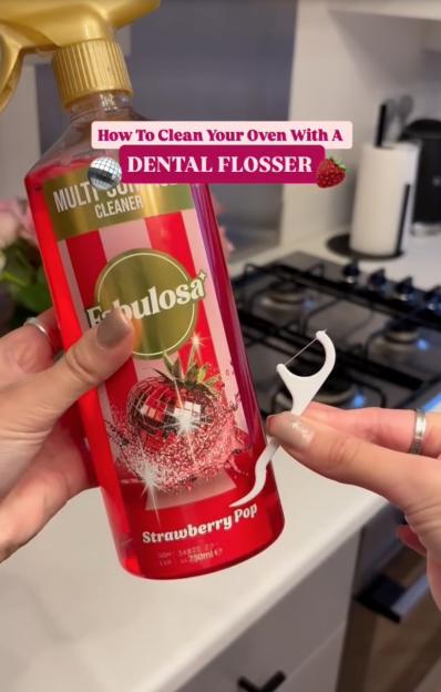 A person holding a bottle of "Fabulosa Strawberry Pop" multi-surface cleaner and a dental flosser, with text overlay "How To Clean Your Oven With A DENTAL FLOSSER."