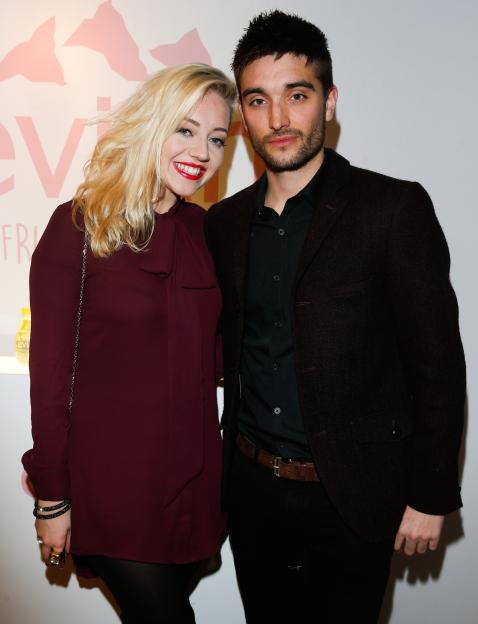 A man and a woman posing together at the Evian product launch event.
