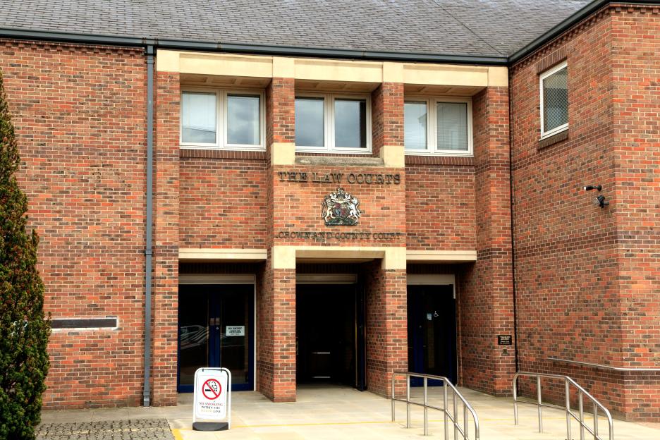 The Norwich Crown Court and County Court building, a red brick law court with "THE LAW COURTS CROWN AND COUNTY COURT" written on it.