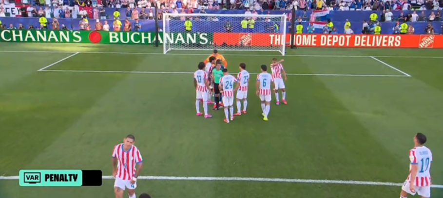 Paraguay players surround the penalty spot after France was awarded a penalty.