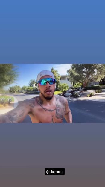 Lewis Hamilton shirtless, running outdoors.
