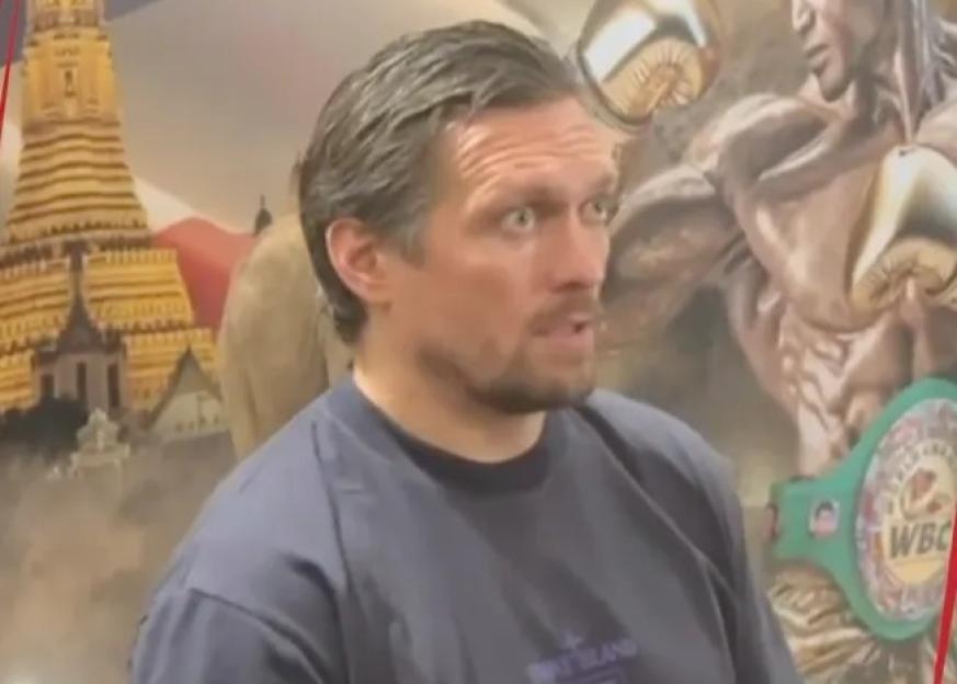Oleksandr Usyk with a boxing mural behind him and "THIS GUY" text overlaid.