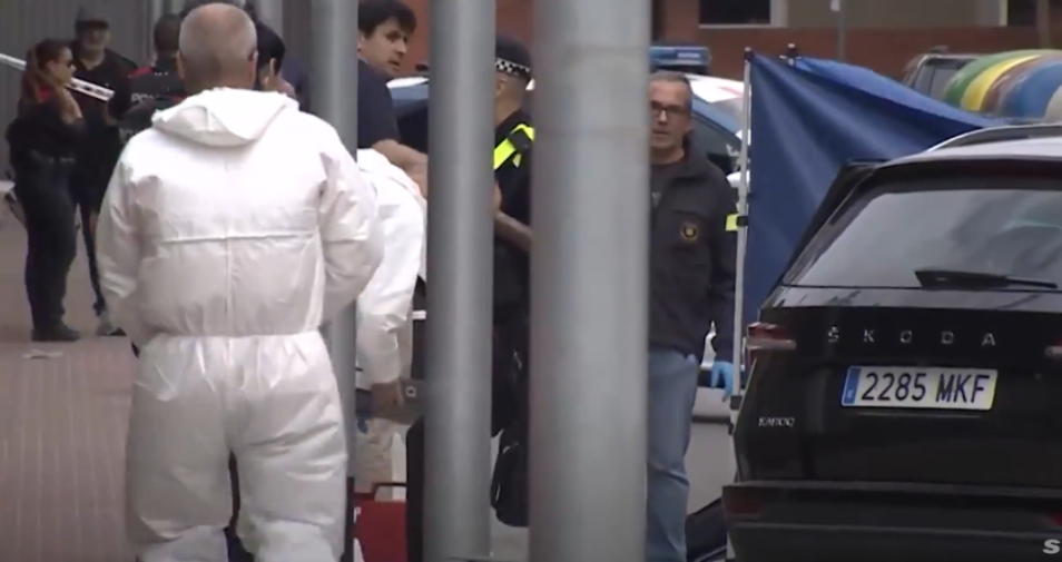 Forensic personnel in white hazmat suits and police officers at a crime scene.
