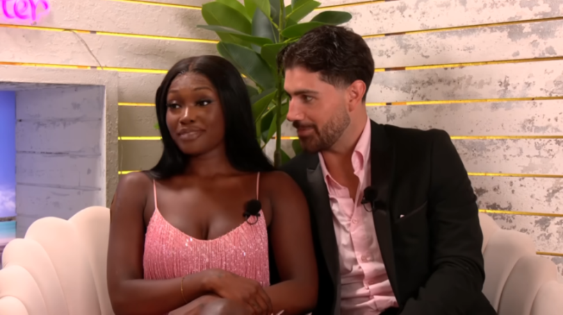 Leanne and Scott from Love Island All Stars sitting on a couch.