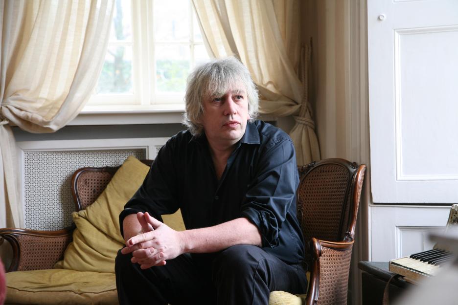 Journalist Rod Liddle sitting in a chair in a room.