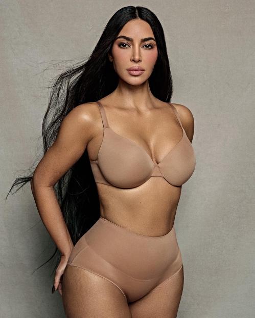 Kim Kardashian wearing a beige bra and matching high-waisted underwear from her brand Skims.