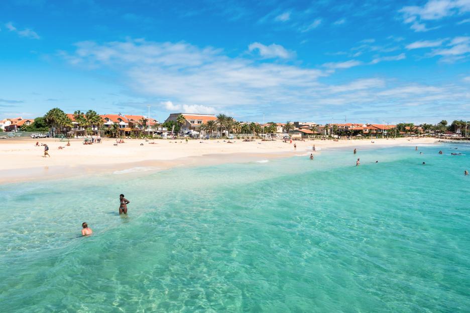 Santa Maria beach in Sal Cape Verde with people swimming and relaxing on the sand.