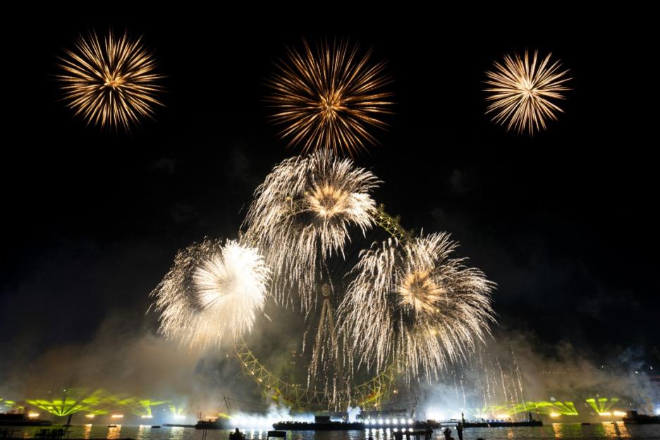 Fireworks explode over the London Eye at night.
