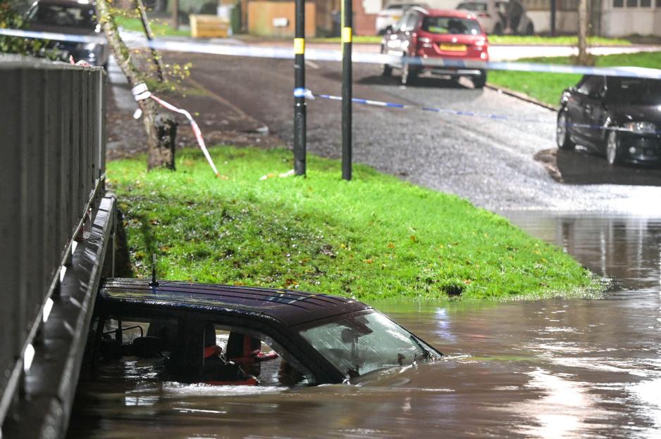 Green Road, Birmingham, Nov 14th 2025 - A 4x4 has been abandoned after the driver risked navigating a flooded ford in the Hall Green area of Birmingham on Friday night. Smashed windows could be seen suggesting the occupants were unable to open the do