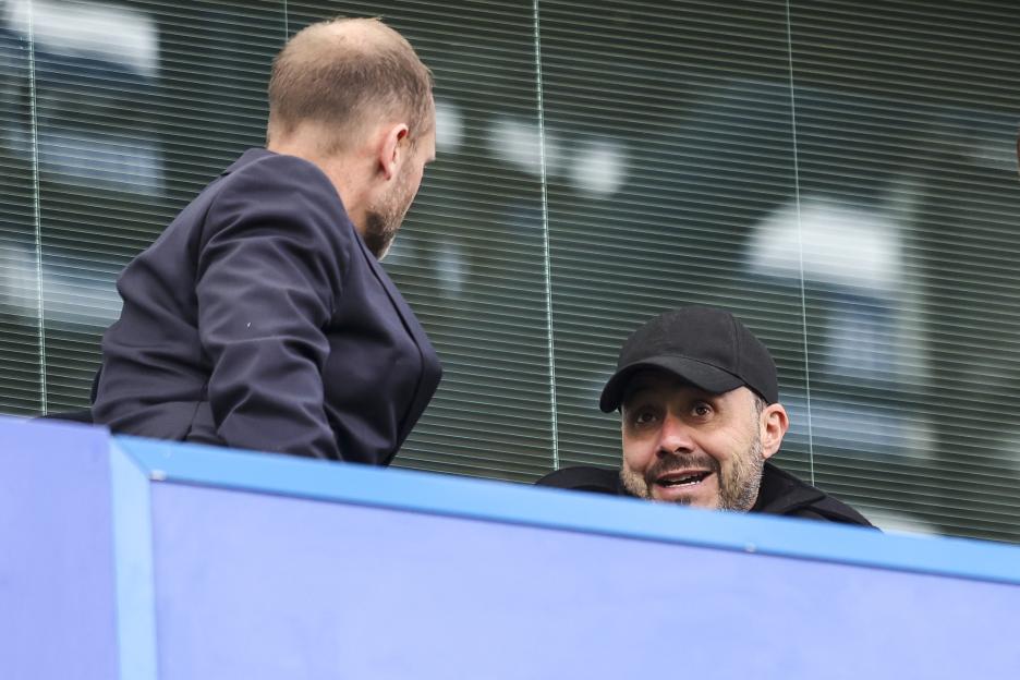 Chelsea Sporting Director Paul Winstanley speaking with Tottenham Hotspur Head Coach Roberto De Zerbi at a Premier League match.