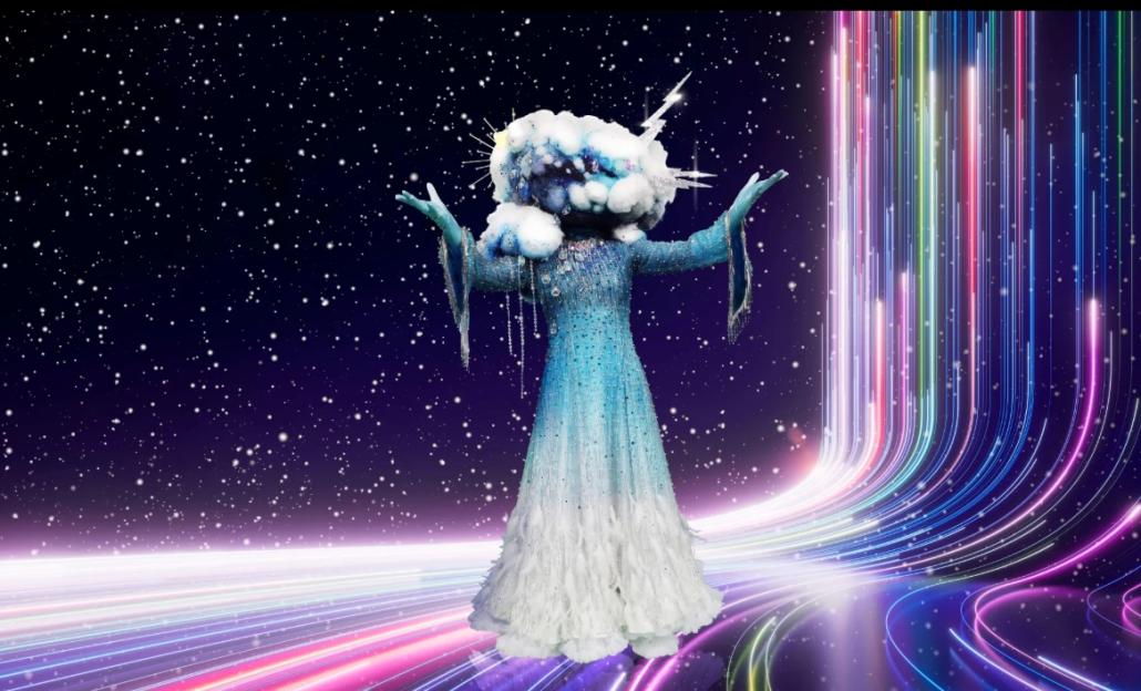 The Masked Singer contestant, Cloud, in a blue and white feathered gown with a cloud headpiece.