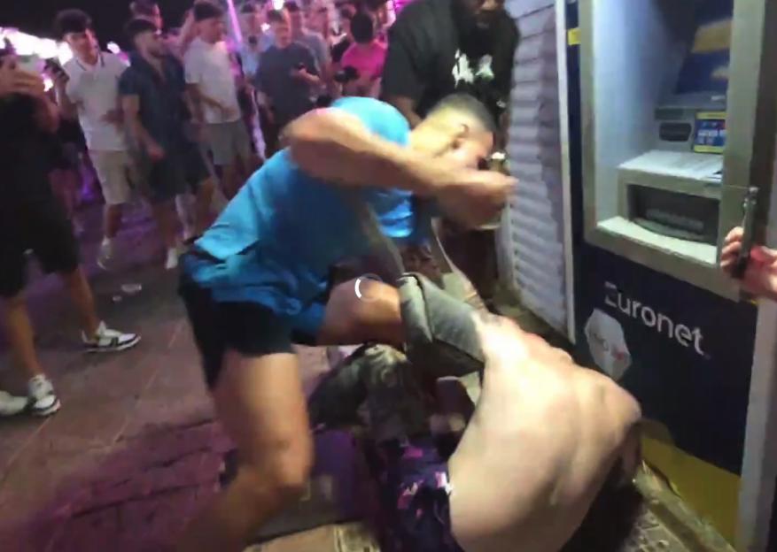 HSTikkyTokky attacking a person on the ground next to a Euronet ATM in Magaluf.