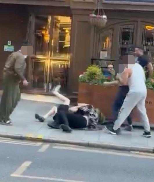 'Daylight Brawl: Women Throw Punches and Yank Hair Before Tumbling to the Ground Outside Spoons'