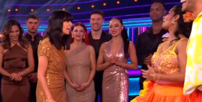 Claudia Winkleman on stage with couples from Strictly Come Dancing.