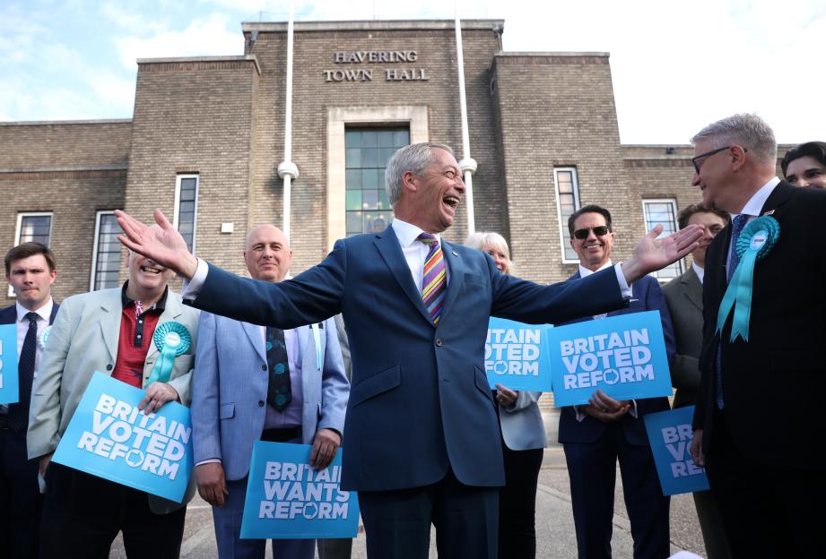 Nigel Farage celebrating with winning Reform UK councillors outside Havering Town Hall.