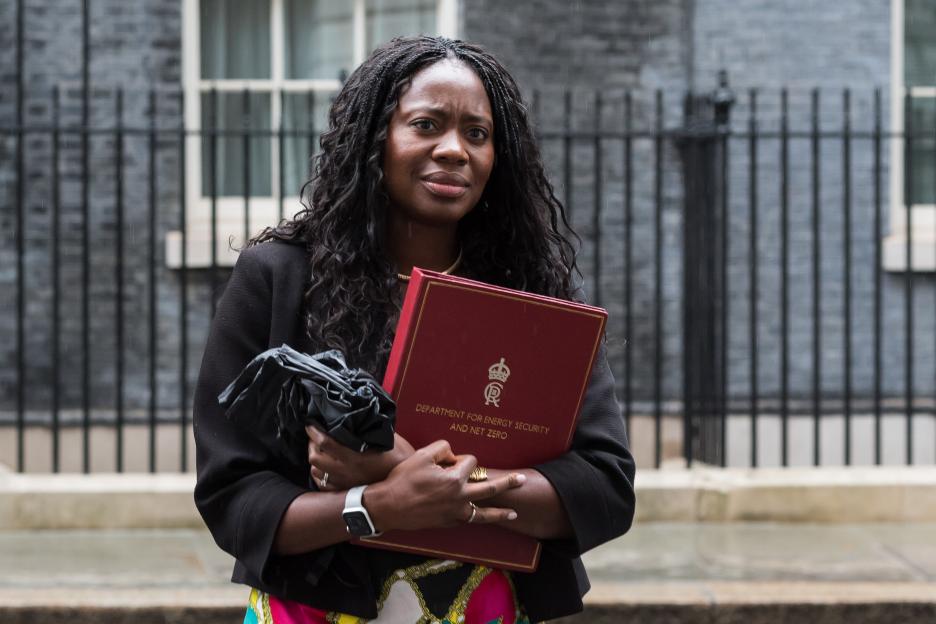 Miatta Fahnbulleh leaving 10 Downing Street, holding a red folder and a black umbrella.