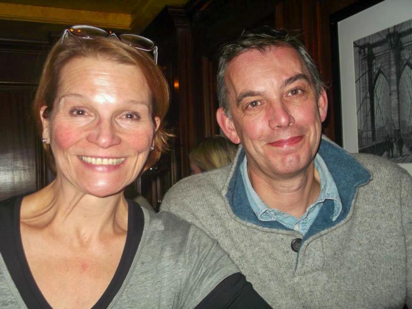 Claire Bridger and her estranged husband Keith smiling, with a framed picture of a bridge in the background.