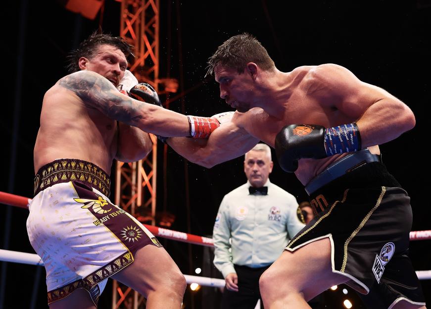 Two boxers exchange blows during Glory in Giza Fight Night.