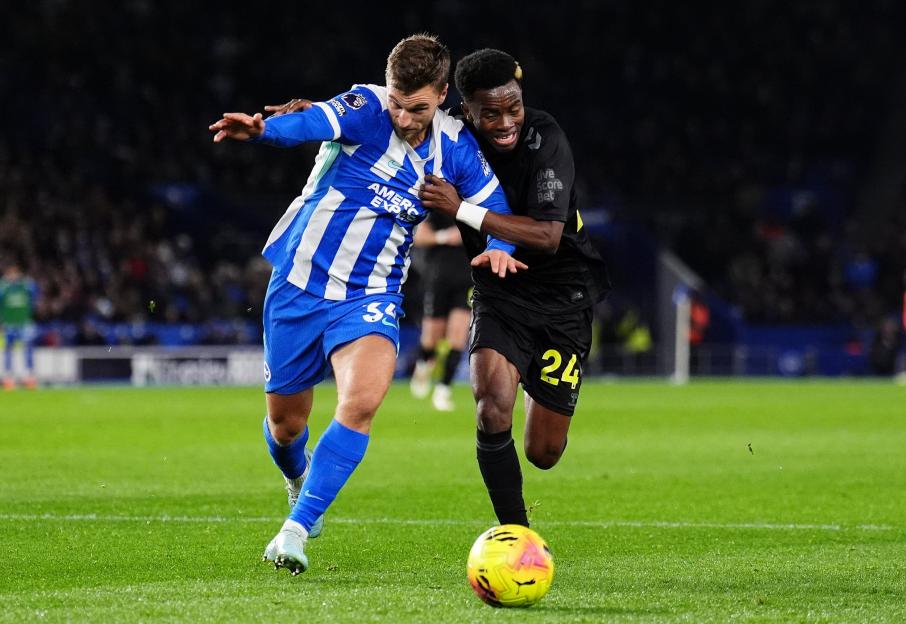 Brighton and Hove Albion player #55 Lewis Dunk and Sunderland player #24 Jewison Bennette battle for the ball.