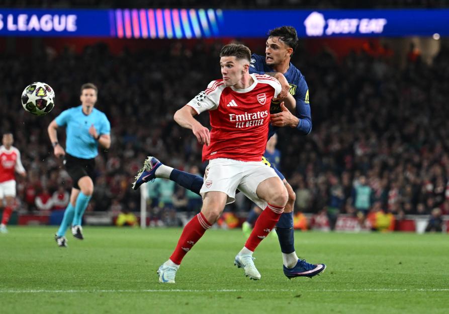 Viktor Gyokeres of Arsenal is held off by Marc Pubill of Atletico during a UEFA Champions League match.
