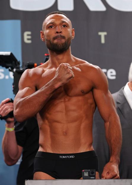 Kell Brook flexing his biceps at the weigh-in event.
