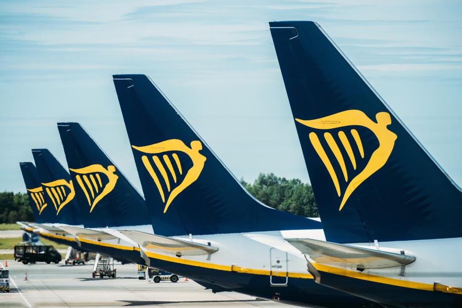A Row of Airplanes belonging to Ryanair Parked at the tarmac at Stansted Airport, London, UK