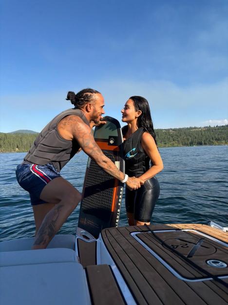 Lewis Hamilton and Kim Kardashian on a boat with a wakeboard.