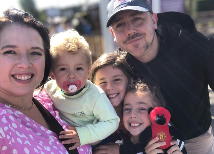 Chloe, Aran, Edison, Darcy, and Bobby pose for a family photo.