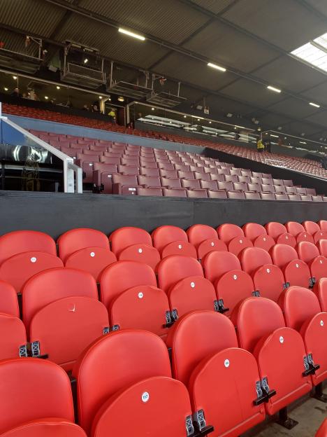 Empty red stadium seats.