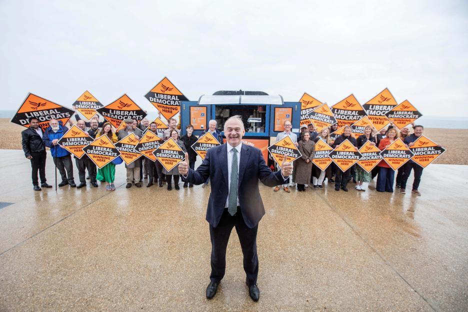 Liberal Democrat leader Sir Ed Davey with supporters holding signs that say "Liberal Democrats Winning Here" after local election gains.