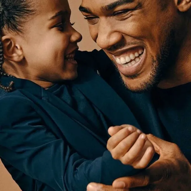 Man and child laughing together.