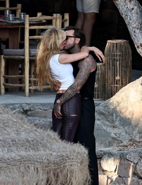 Olivia Attwood and Pete Wicks kissing passionately while embraced.