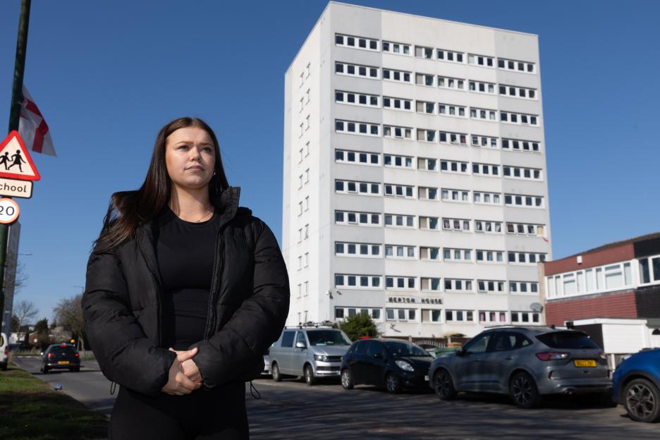 Bobbie Goodman standing in front of Merton House tower block.