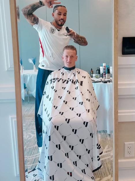Footballer Jordan Pickford getting a haircut from Jude Bellingham's barber, Luis Andres Rivera.