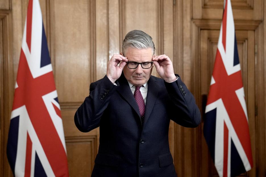 Britain's Prime Minister Keir Starmer adjusts his glasses inside 10 Downing Street.