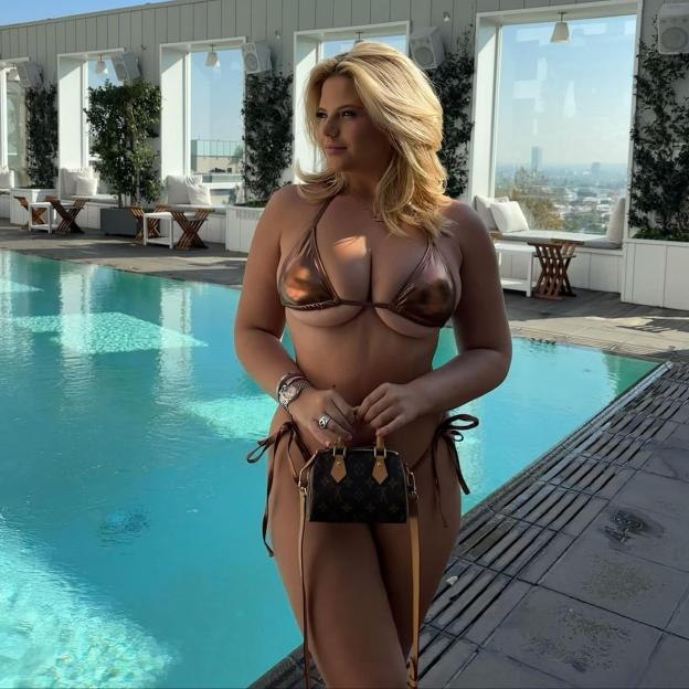 a woman in a bikini is standing next to a pool