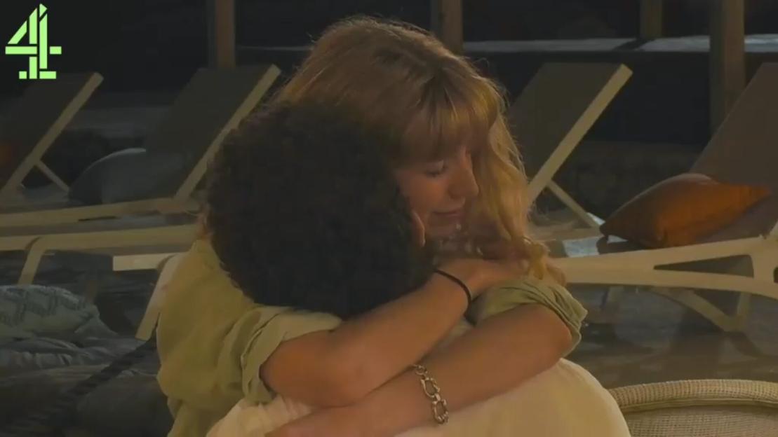 Two reality TV co-stars share a romantic embrace.
