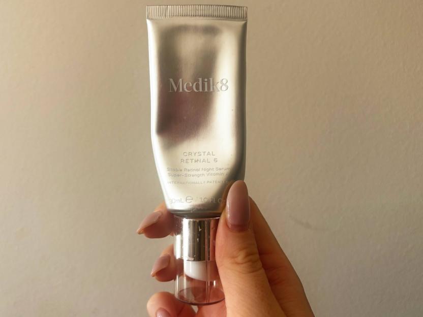 Hand holding a tube of Medik8 Crystal Retinal 6.