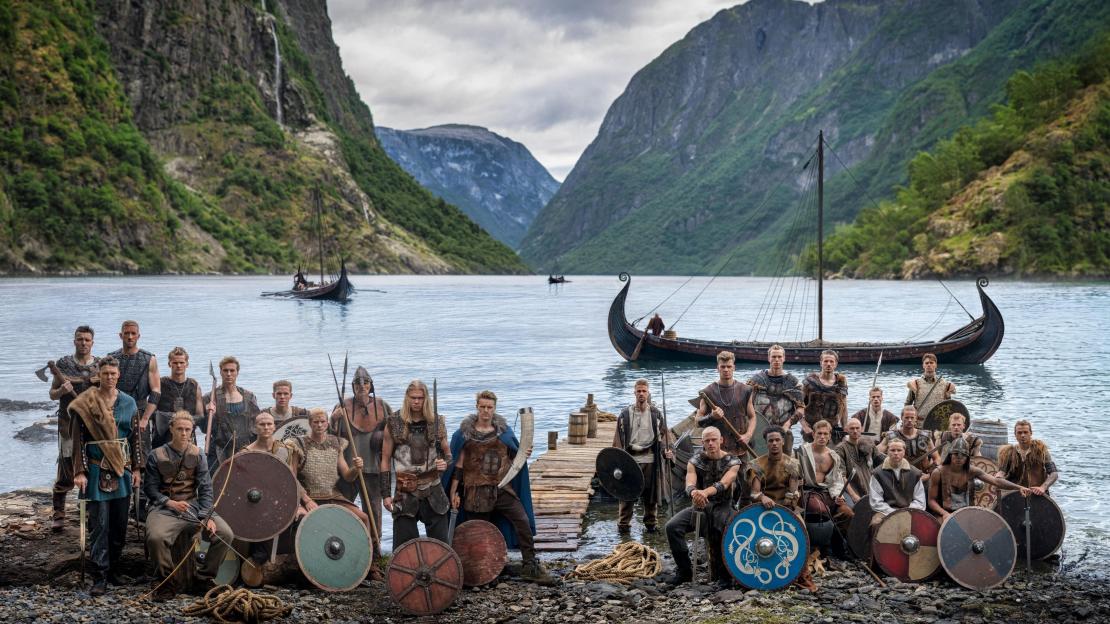 Norway national football team players dressed as Vikings with longships in a fjord.