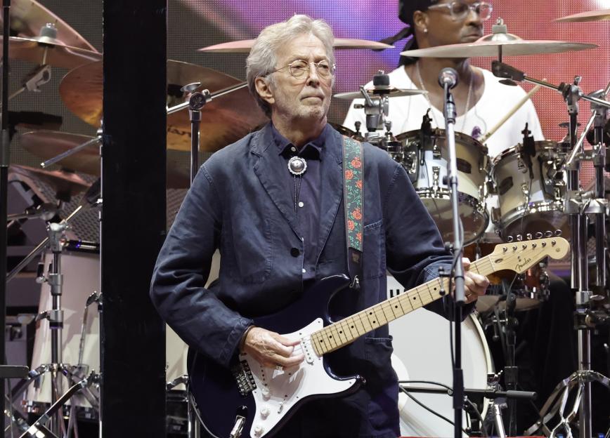 Eric Clapton performing onstage with a guitar at the Crossroads Guitar Festival.