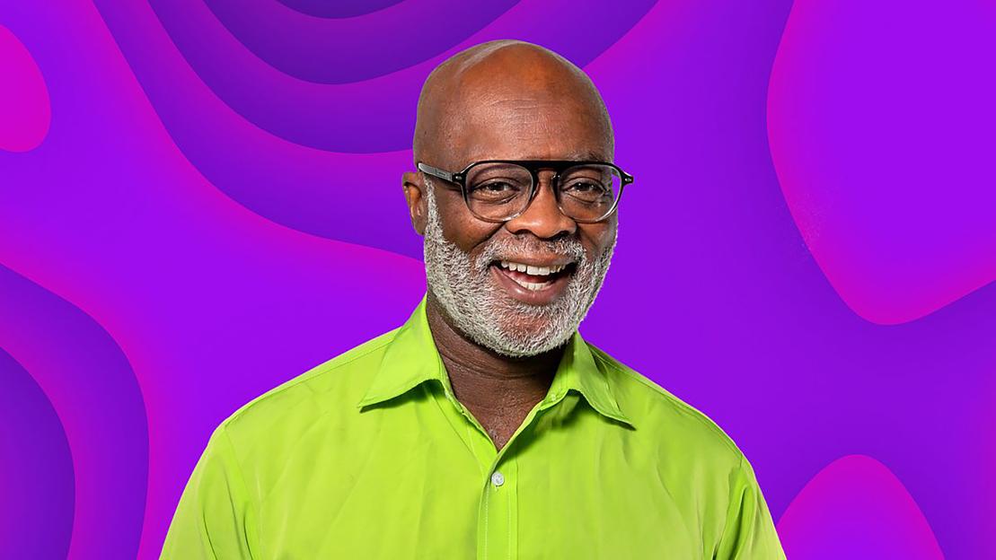 BBC Radio London's Eddie Nestor smiles against a purple background.