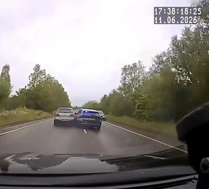 Dashcam footage showing a blue police car ramming into a white car.