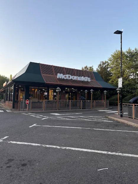 A McDonald's restaurant with a drive-thru lane.