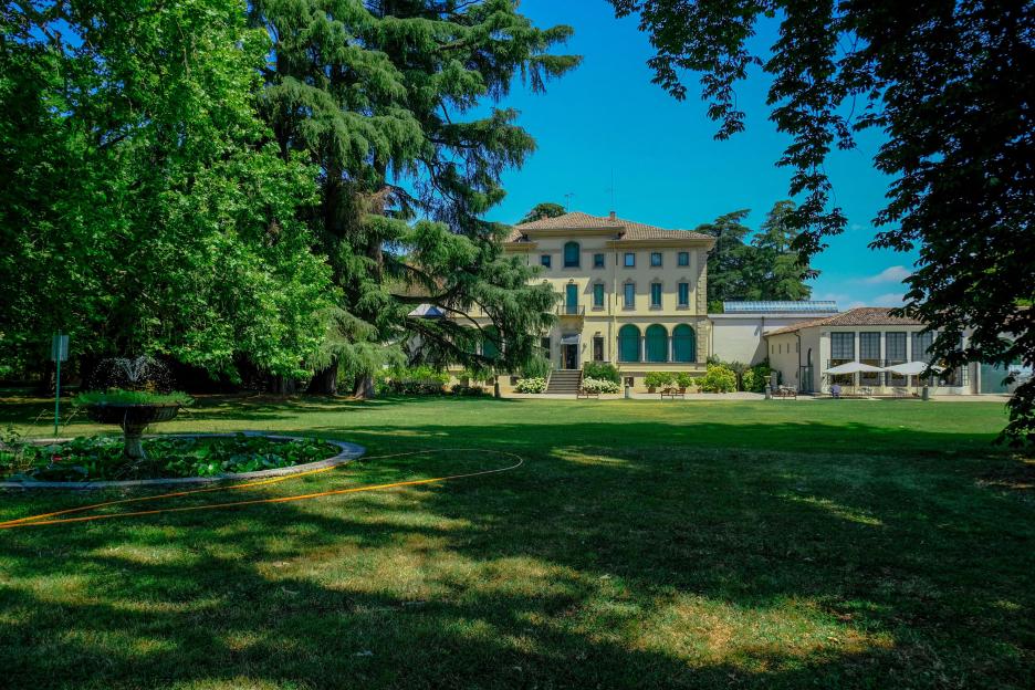 June 2021 Parma, Italy: Fondation Magnani Rocca. Beautiful building of museum, garden with fountains, flowers, trees, and bushes.