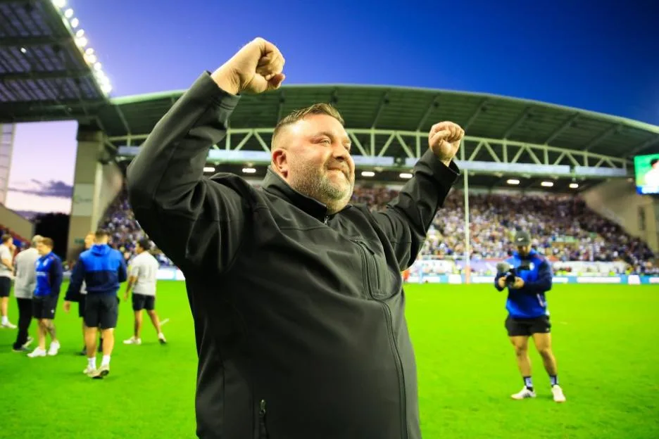 A man celebrates on the pitch after a Wigan Warriors v Wakefield Trinity match.