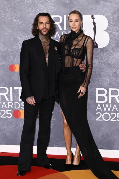 Pete Wicks and Olivia Attwood pose at The BRIT Awards 2025.