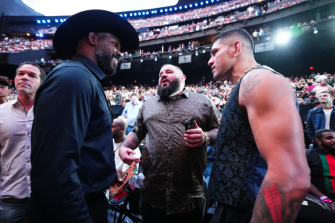 Fighters Glover Teixeira and Alex Pereira talking in a crowded stadium.