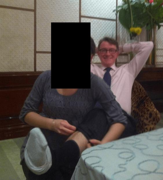 Peter Mandelson sitting next to a person whose face is blacked out.